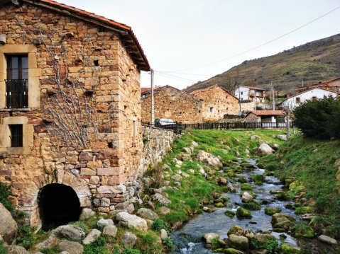 Stone house with river during Camino Lebaniego