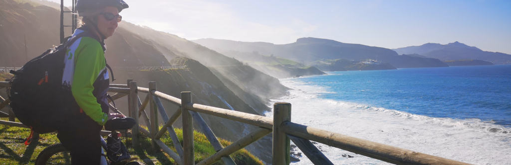 Cyclist staring at sea during Camino del Norte cycling